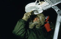 Dr. H.C. Hoinkes, Austrian IGY Meteorologist checks radiation reading device during the winter night of 1957. thumbnail