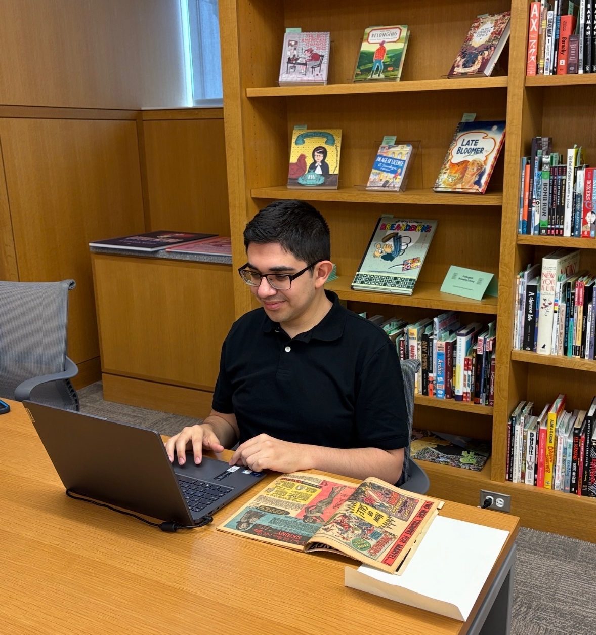 Sebastian Martinez using laptop in library reading room