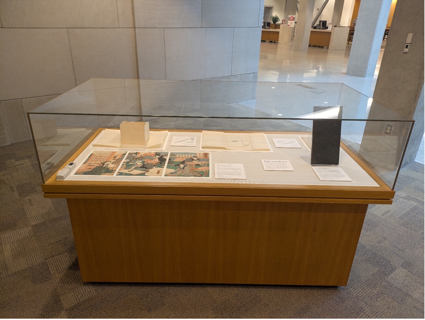 A glass case display with rare Japanese objects