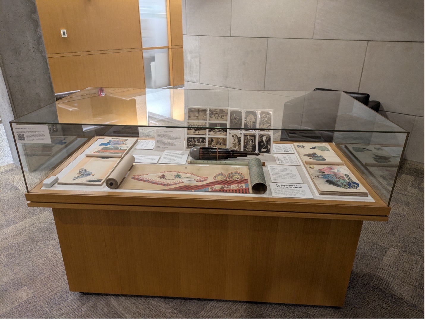 A glass case display of Japanese theater collections