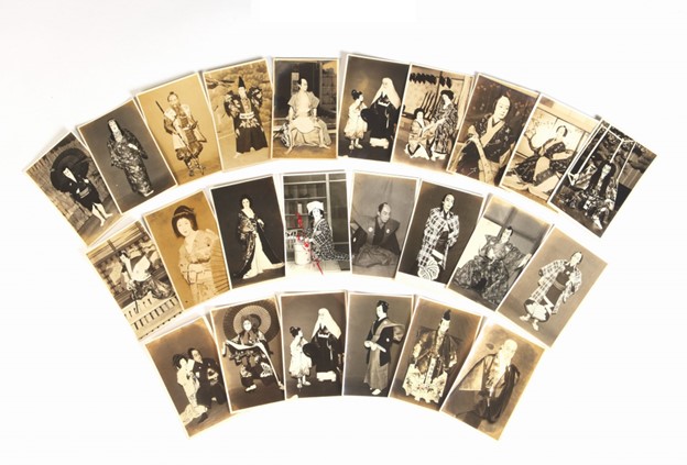 A group of postcards featuring kabuki actors, fanned out for display.