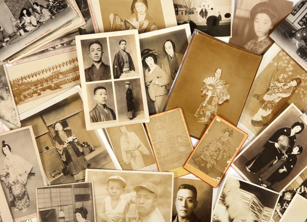 A close-up of a pile of postcards featuring kabuki actors.