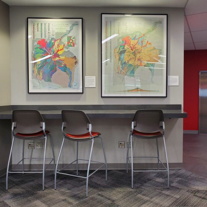 A reading space with two maps hanging on the wall