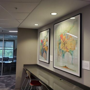 A reading space with two maps hanging on the wall