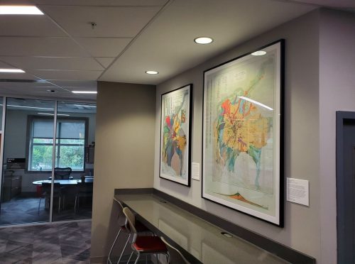 A reading space with two maps hanging on the wall