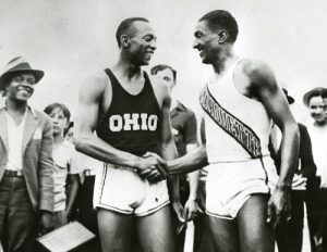 Jesse Owens shakes hands with a competitor in 1935.