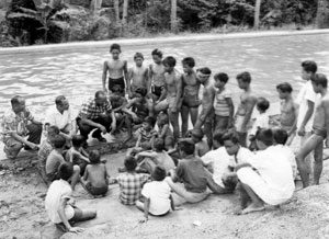 Jesse Owens visits with children in the Philippines in the 1950s.