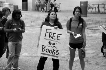 High school girls holding up sign that reads "Free the books"